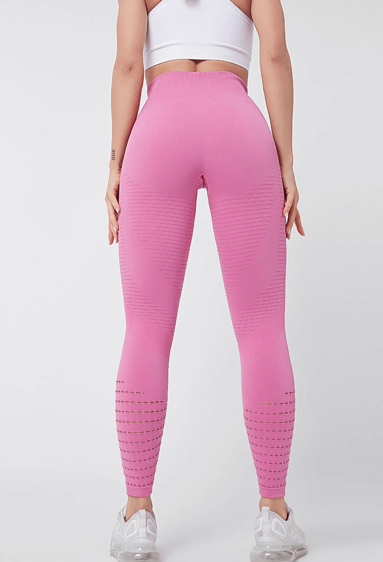 Back view of pink high-waisted hollow seamless leggings for women, showing breathable, booty-lifting design.